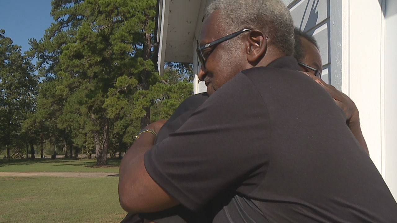 Pastor Rhodes and Moore hugging.jpg